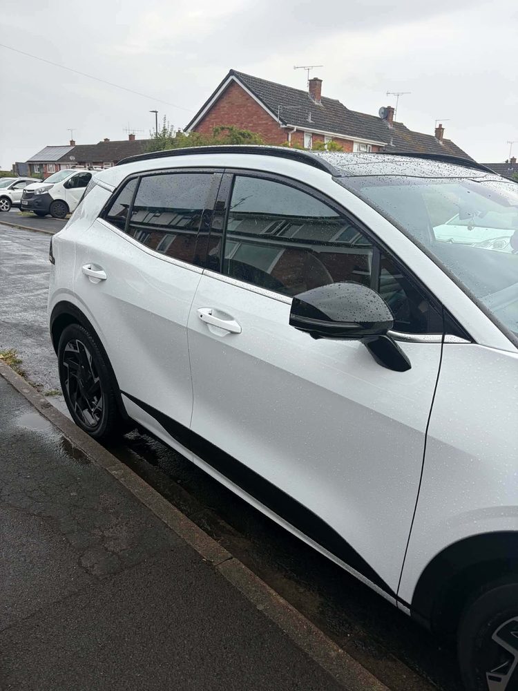 The side of a white Kia parked on a road after a mobile valet in Hereford